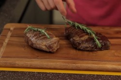 Стейк из говядины с розмарином на сковороде гриль